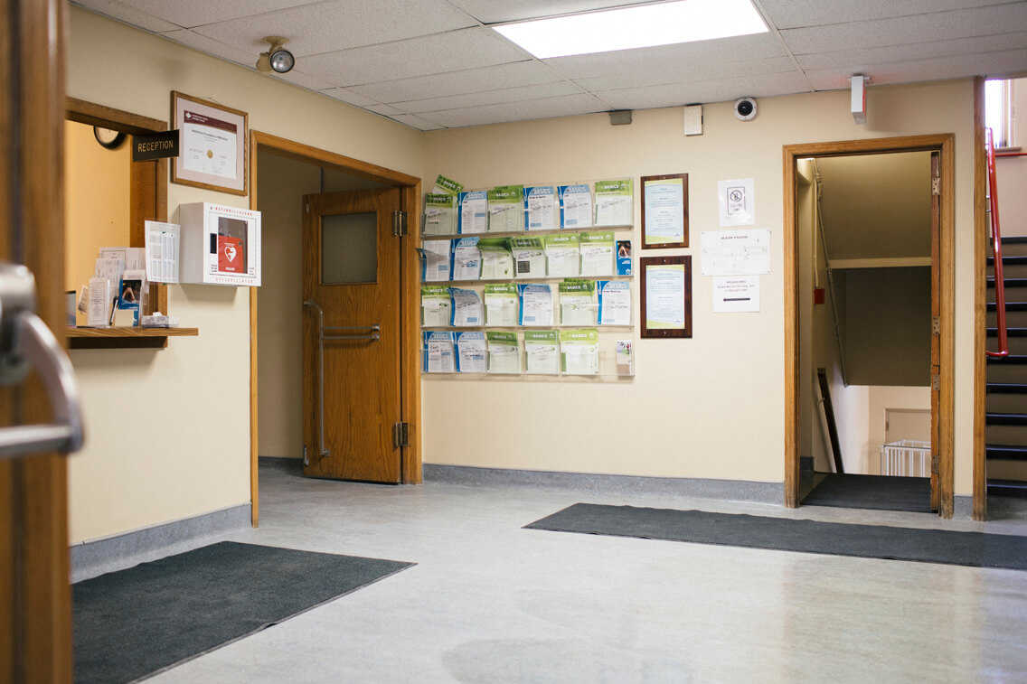 Reception With Stairs Leading Up To Dorm Rooms And Basement